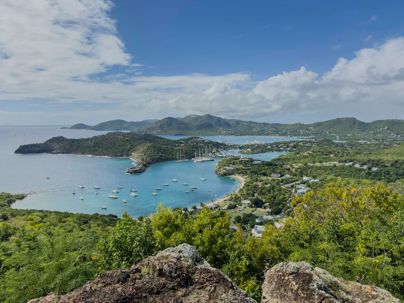 Sailing yachts and green hills around English Harbour in Antigua